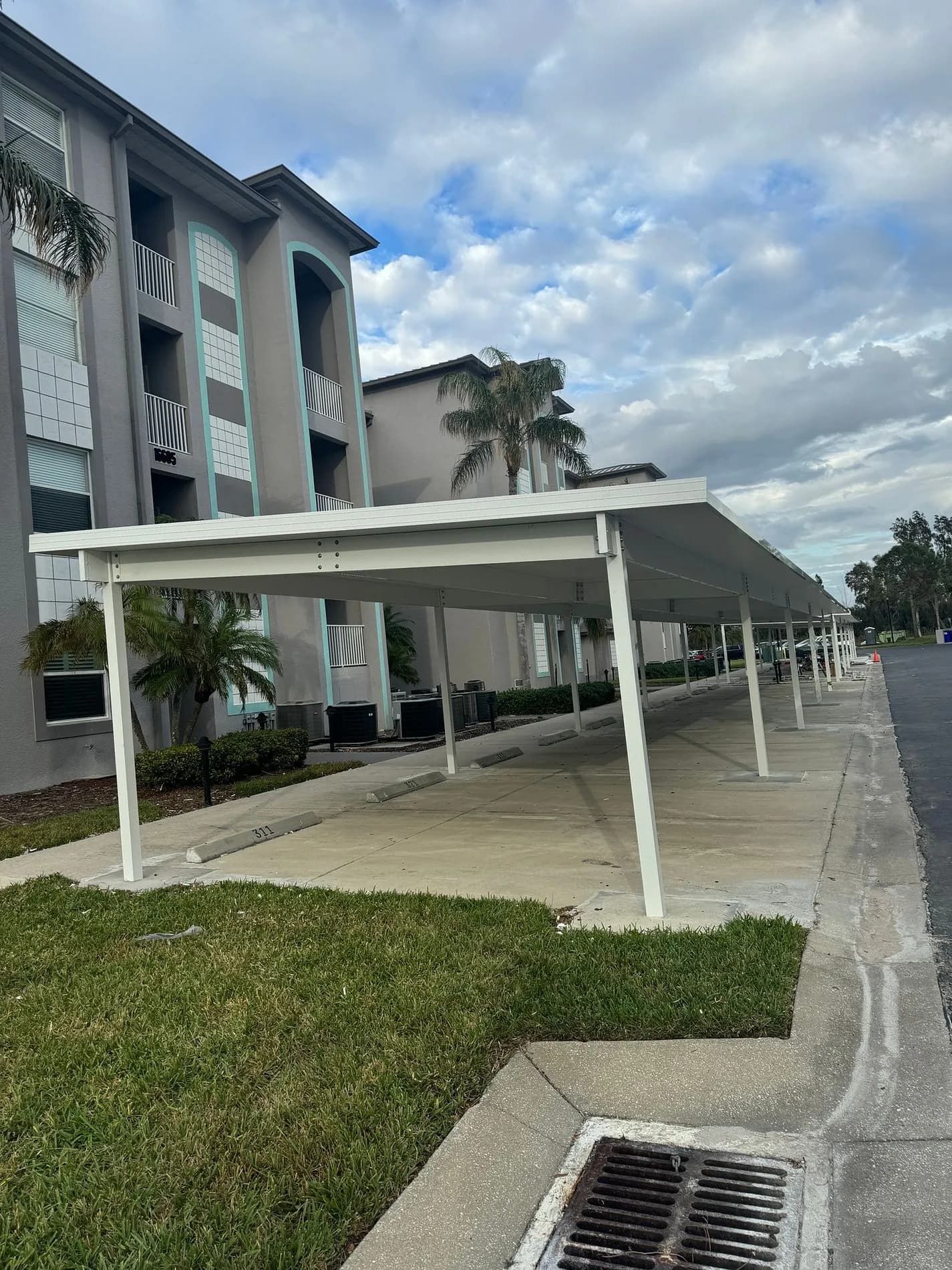 Completed white metal carport structure at Heritage Pointe in Fort Myers