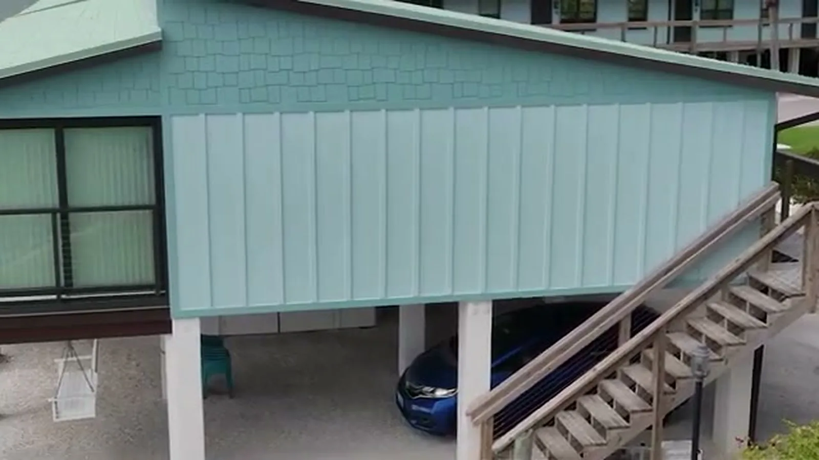 Representative board-and-batten fiber-cement siding with a shake-style gable on a Southwest Florida waterfront home