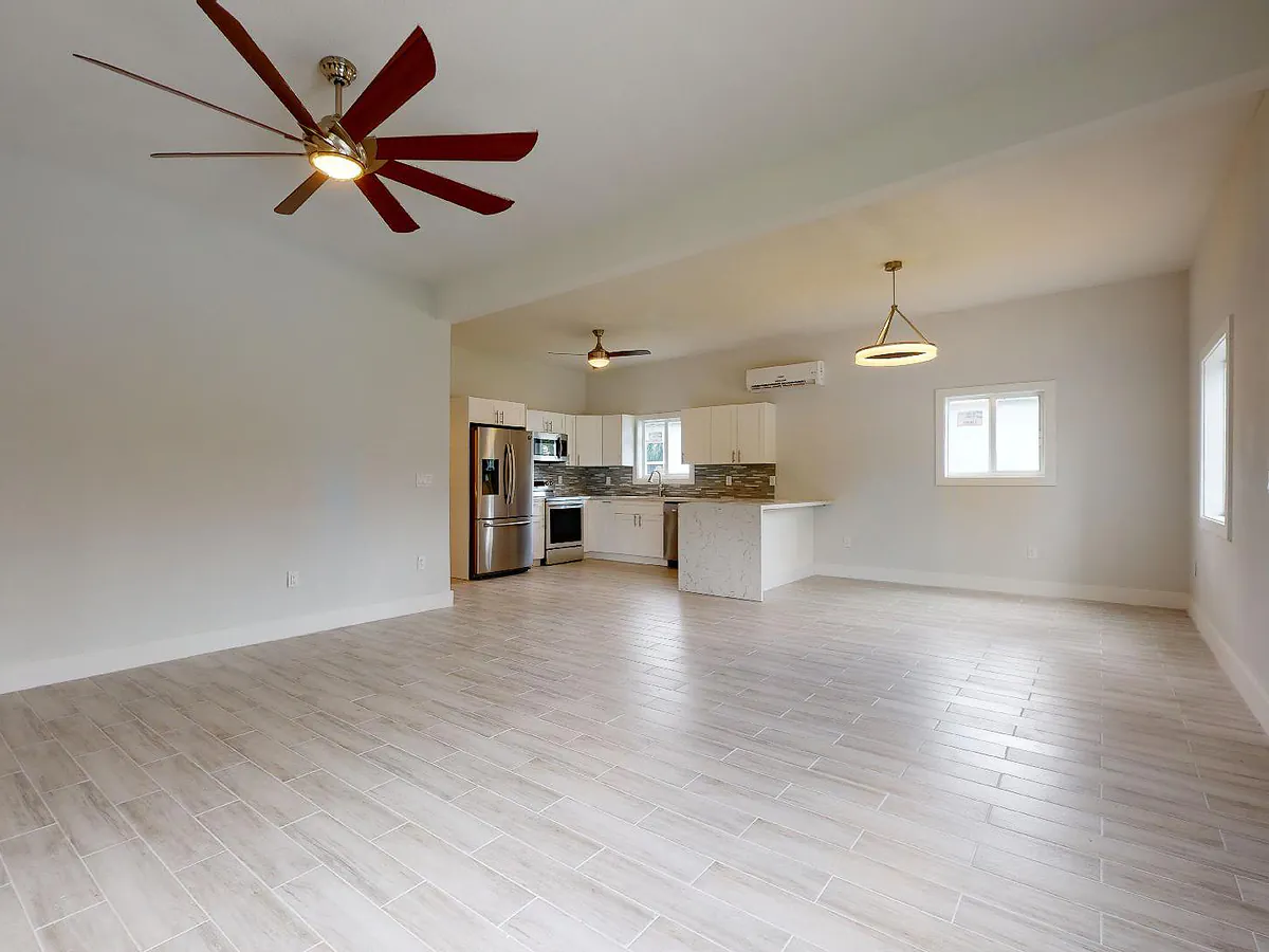 Finished open-plan living and kitchen area from a Safe Room Designs structural insulated panel project