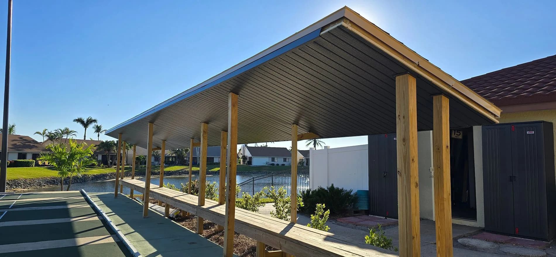 Covered seating beside the Cinnamon Cove shuffleboard courts