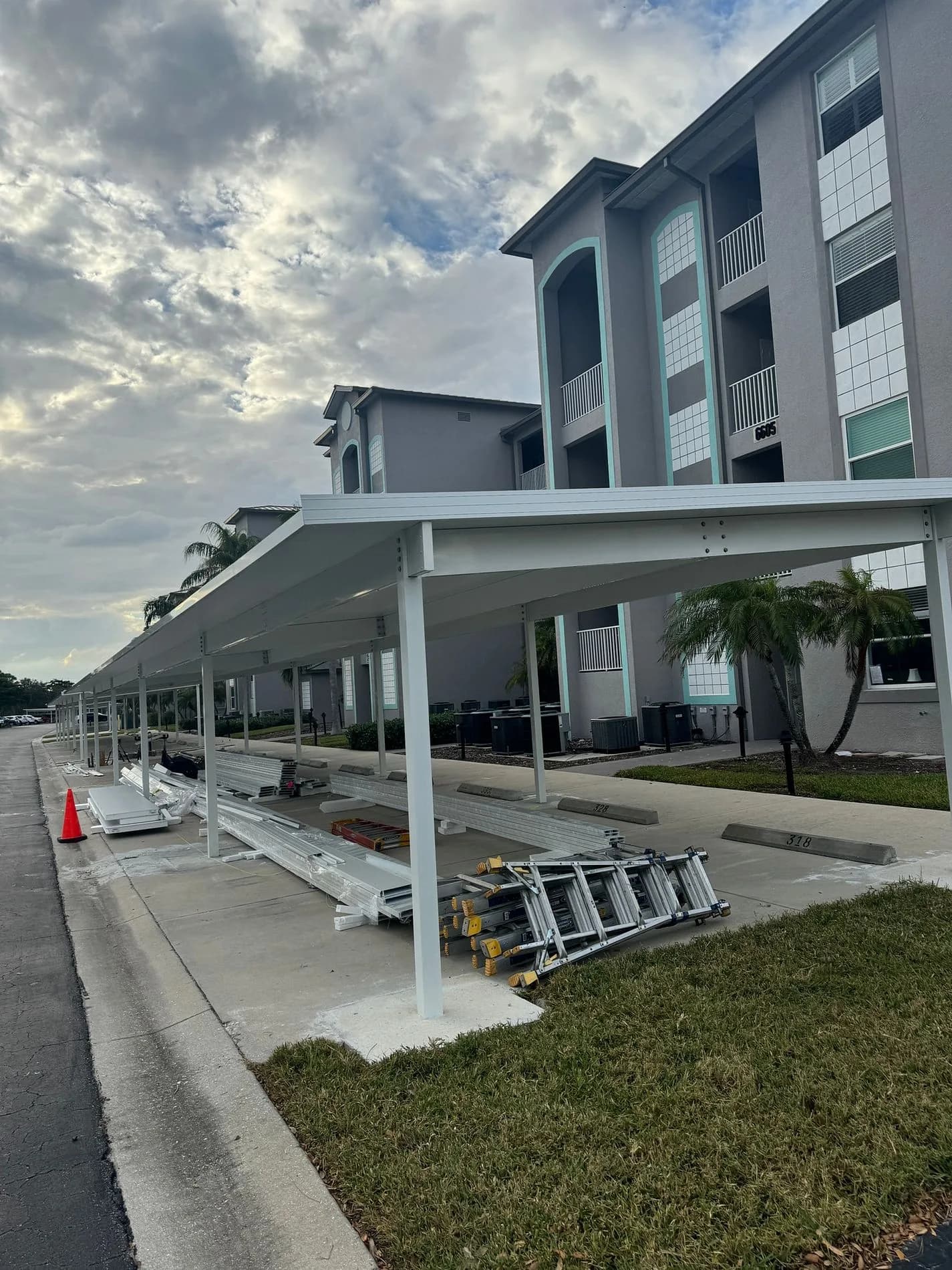 Steel carport roof panels and framing during installation at Heritage Pointe