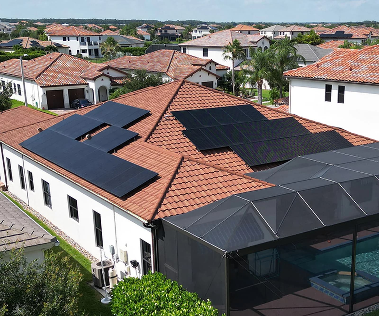 Representative aerial view of black solar panels on a barrel-tile roof in Southwest Florida